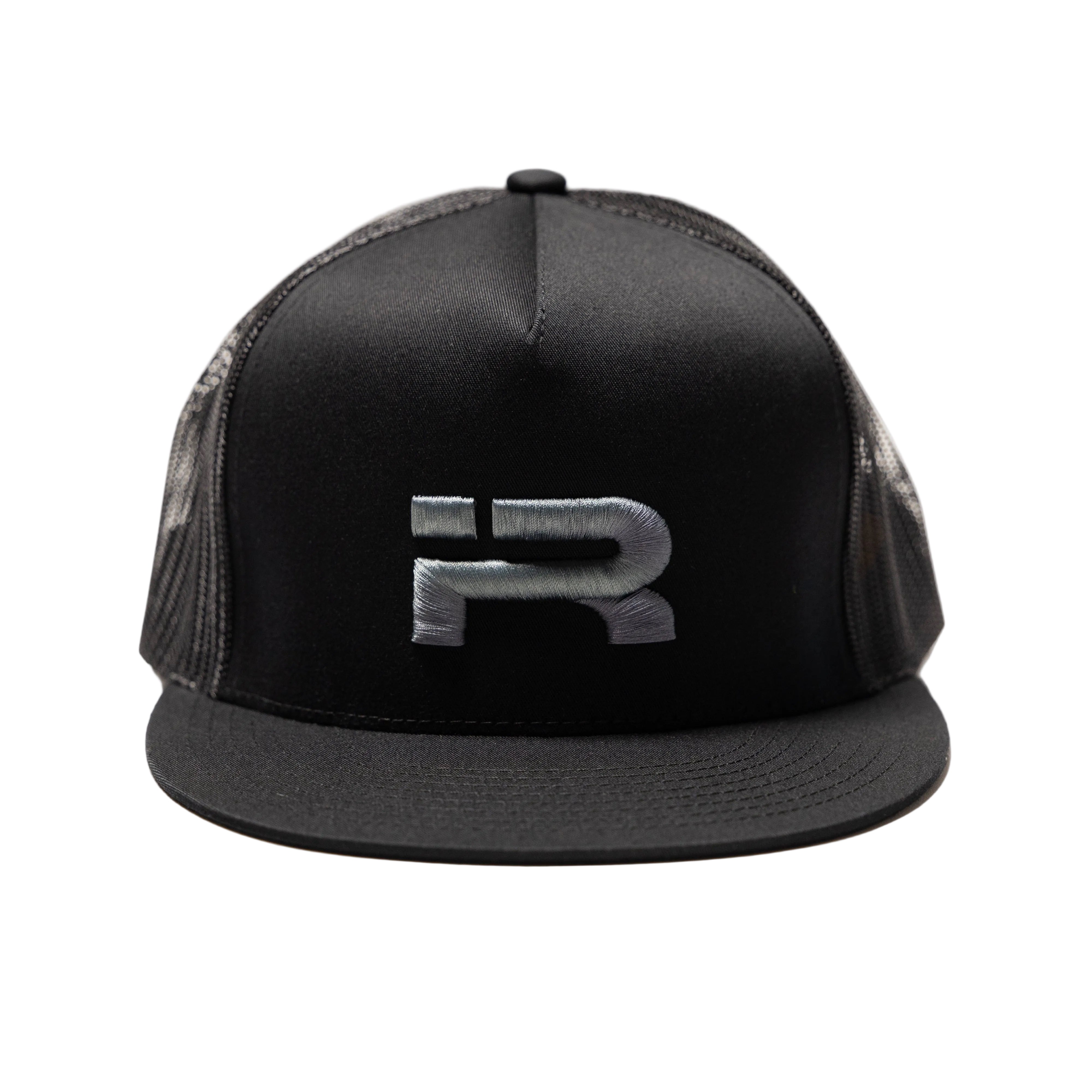A black trucker-style cap with a structured front panel, black flat brim, and black mesh back, featuring a metallic silver 'R' logo on the front.